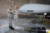 In this photo released on Saturday, May 28, 2022 by website of the Iranian Army, Chief of the General Staff of the Armed Forces Gen. Mohammad Hossein Bagheri, right, and Commander of the Army Gen. Abdolrahim Mousavi talk while visiting an underground drone base tunnel of the Army in the heart of the country's western Zagros Mountains. Iranian state television's report said Saturday, May 29, the tunnel was some 100 meters (330 feet) underground and was home to the Kaman-22 and Fotros drones, both capable of carrying cruise missiles. (Iranian Army via AP)