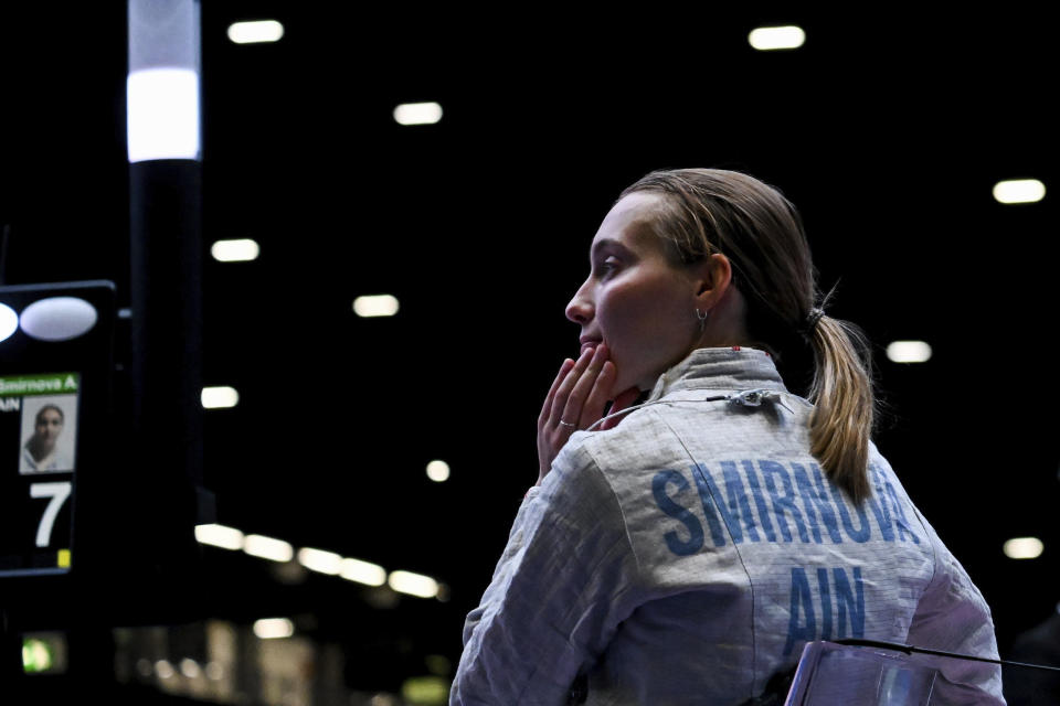 Russia's Anna Smirnova remains seated after her bout with Ukraine's Olga Kharlan in the women's individual sabre best of 64 round match at the World Fencing Championship in Milan, Italy, Thursday, July 27, 2023. Olympic champion Kharlan competed against officially-neutral Russian opponent Smirnova at the world fencing championships, an Olympic qualifier, on Thursday in Milan, Italy, winning their bout 15-7. However, Smirnova refused to leave after the bout in an apparent protest because Kharlan refused to shake hands at the end. (Tibor Illye/MTI via AP)