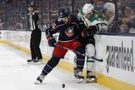 Columbus Blue Jackets' Dean Kukan, left, checks Dallas Stars' Miro Heiskanen away from the puck during the first period of an NHL hockey game Monday, Oct. 25, 2021, in Columbus, Ohio. (AP Photo/Jay LaPrete)