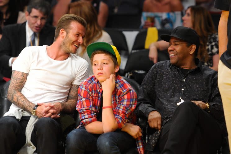 David Beckham, Brooklyn Beckham, and Denzel Washington at an L.A. Lakers game in 2012 (Photo: Getty Images)