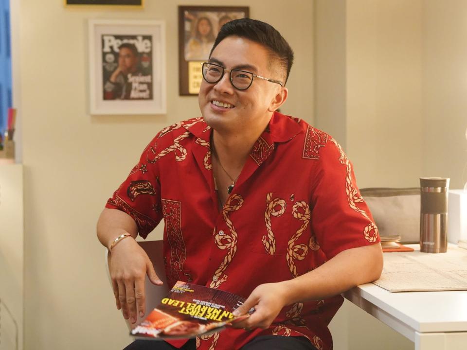 Bowen smiling in glasses and a red shirt.