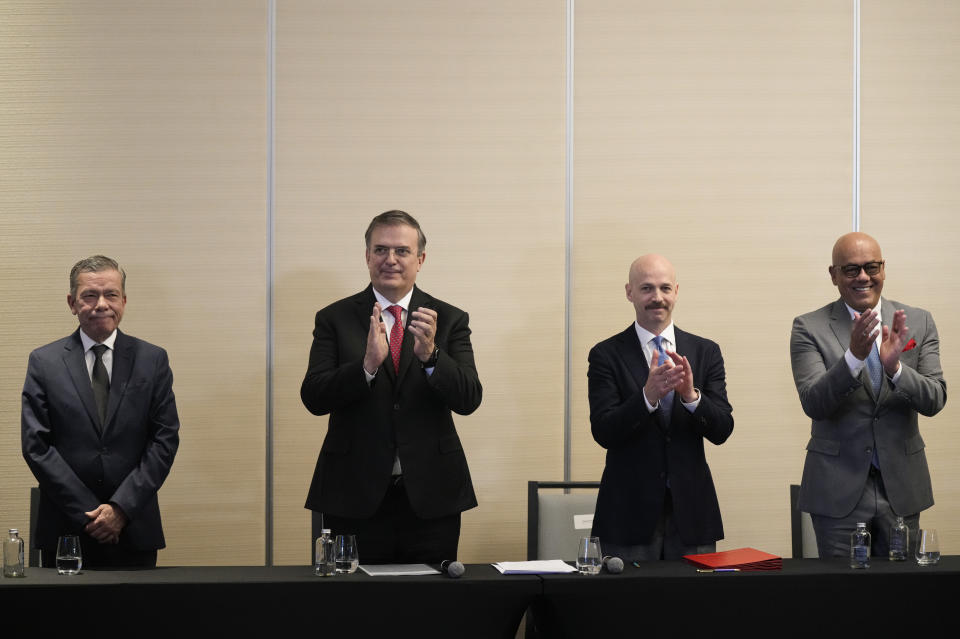 From left, Venezuelan opposition delegate Gerardo Blyde Perez, Mexico's Foreign Minter Marcelo Ebrad, Norwegian diplomat Dag Nylander and President of the National Assembly of Venezuela, Jorge Rodriguez, applaud after signing an agreement to create a U.N.-managed fund to finance health, food and education programs for the poor during a ceremony at a hotel in Mexico City, Saturday, Nov. 26, 2022. The agreement signed by representatives of Venezuelan President Nicolás Maduro and the opposition marked the resumption of long-stalled negotiations meant to find a common path out of their country's complex crisis. The U.S. government, in response, agreed to allow oil giant Chevron to pump Venezuelan oil. (AP Photo/Fernando Llano)
