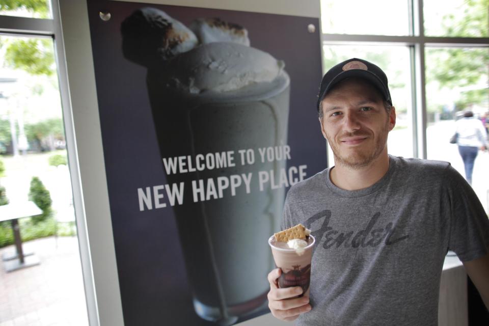 In this May 7, 2012 photo, "Top Chef" star Spike Mendelsohn poses with a specialty milkshake at his new Good Stuff Eatery restaurant in Crystal City, Arlington, Va. (AP Photo/Charles Dharapak)