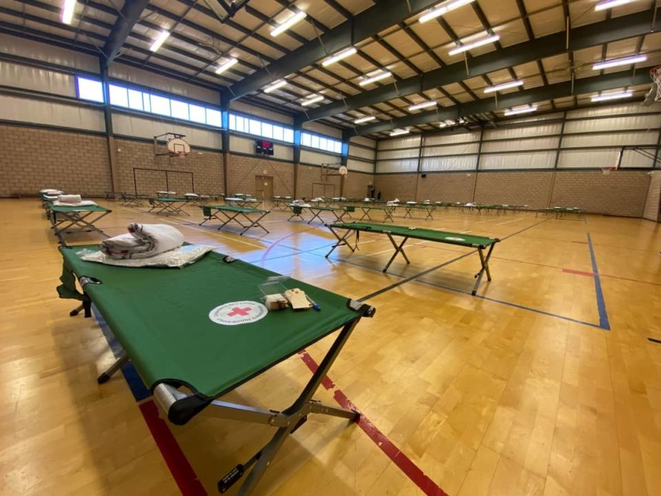 Cots set up inside the gym of the John Atkinson Memorial Community Centre, which is being used as an emergency shelter for displaced residents of an apartment building at 1616 Ouellette Ave.  (Jason Viau/CBC - image credit)