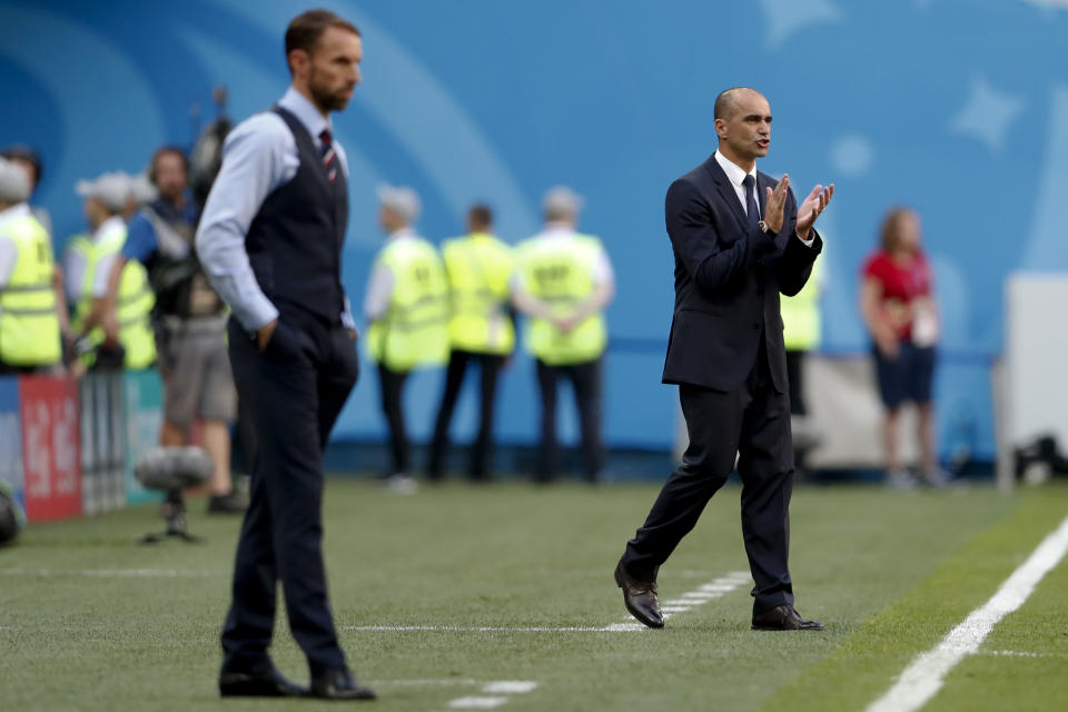 FILE - in this photo taken on Saturday, July 14, 2018, Belgium coach Roberto Martinez, background, applauds behind England head coach Gareth Southgate during the third place match between England and Belgium at the 2018 soccer World Cup in the St. Petersburg Stadium in St. Petersburg, Russia. Martinez has signed a new contract to lead the Red Devils through the 2022 World Cup in Qatar. (AP Photo/Natacha Pisarenko)