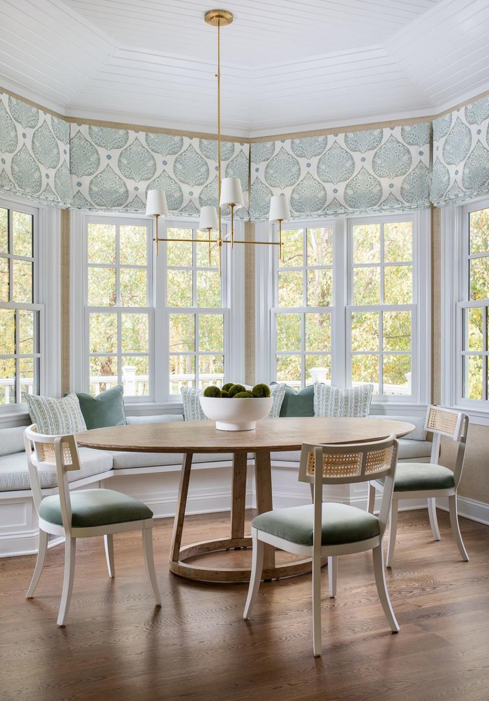 a dining room with a table and window seat