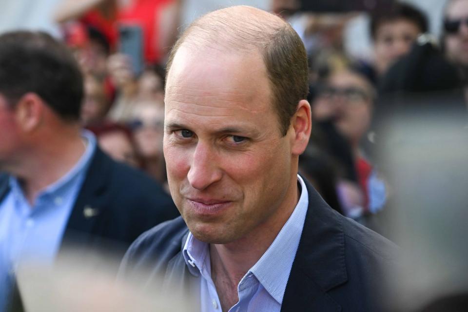 <p>Finnbarr Webster/Getty</p>  Prince William, Prince of Wales speaks to people during a walkabout in Windsor on May 7.