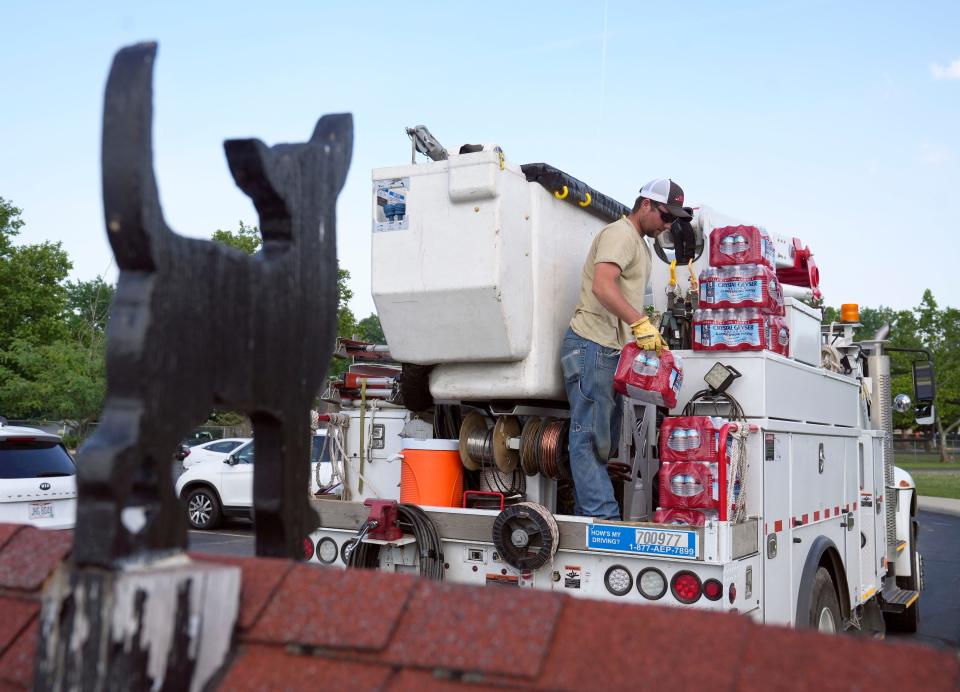 AEP Ohio trucks that were working in the area bought ice and bottled water to donate after the Franklin County Dog Shelter & Adoption Center lost power and had no air conditioning on Tuesday, June 14, 2022.