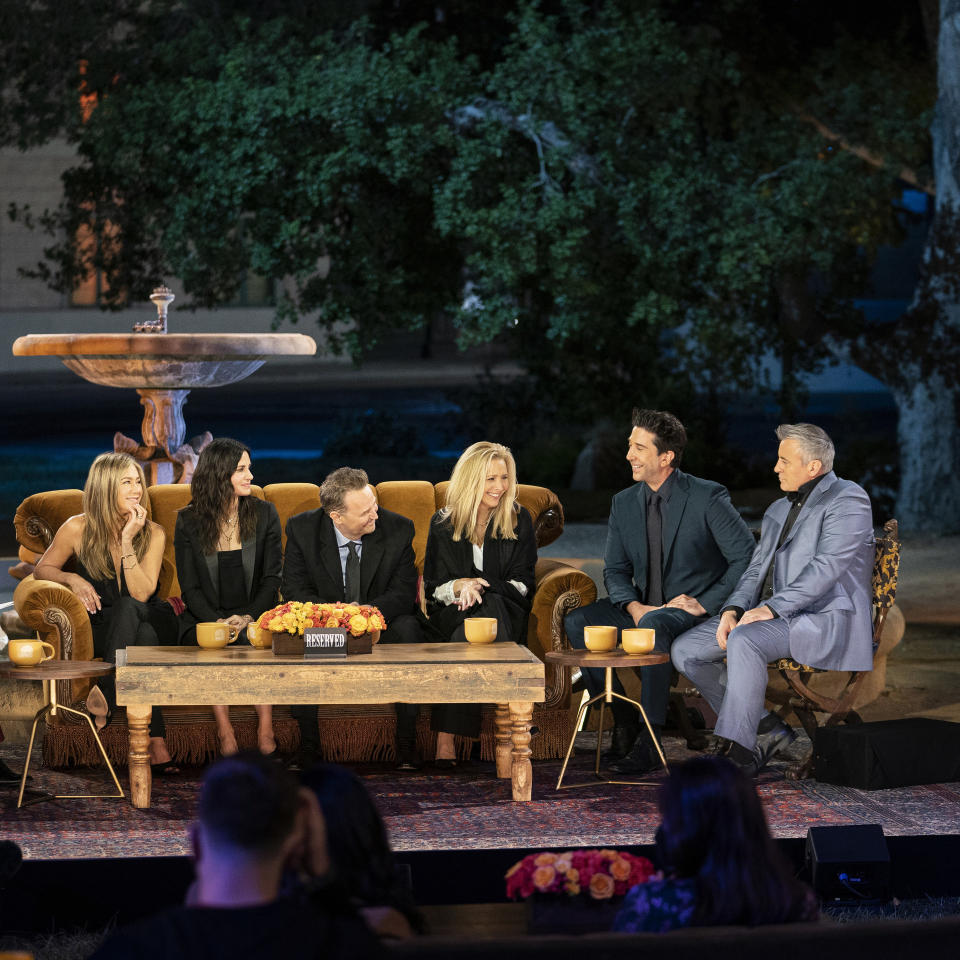 The cast in front of a fountain during the reunion