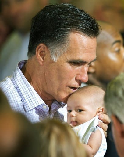 Republican presidential hopefull Mitt Romney kisses a baby from the crowd after delivering remarks on the economy in Irwin, Pennsylvania. Campaigning ahead of November's presidential vote has become increasingly rancorous, as President Barack Obama and Romney trade attack ads and bitter accusations of lies and cover-ups