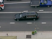 Hughes' coffin being driven away.