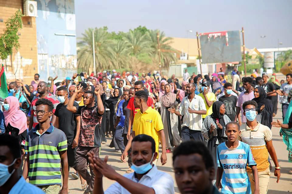 Thousands of pro-democracy protesters take to the streets to condemn a takeover by military officials in Khartoum, Sudan, Monday Oct. 25, 2021. Sudan’s military seized power Monday, dissolving the transitional government hours after troops arrested the acting prime minister and other officials. The takeover comes more than two years after protesters forced the ouster of longtime autocrat Omar al-Bashir and just weeks before the military was expected to hand the leadership of the council that runs the African country over to civilians. (AP Photo/Ashraf Idris)