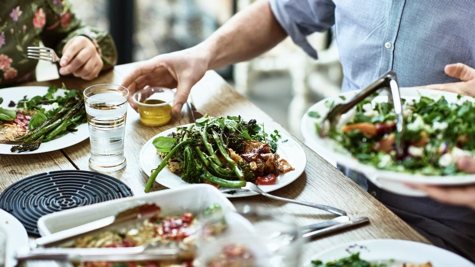 People serving a vegan meal