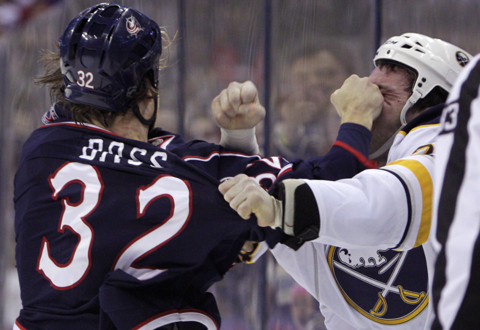 Columbus Blue Jackets' Cody Bass, left, and Buffalo Sabres' Zenon Konopka fight during the first period of an NHL hockey game, Saturday, Jan. 25, 2014, in Columbus, Ohio. (AP Photo/Jay LaPrete)