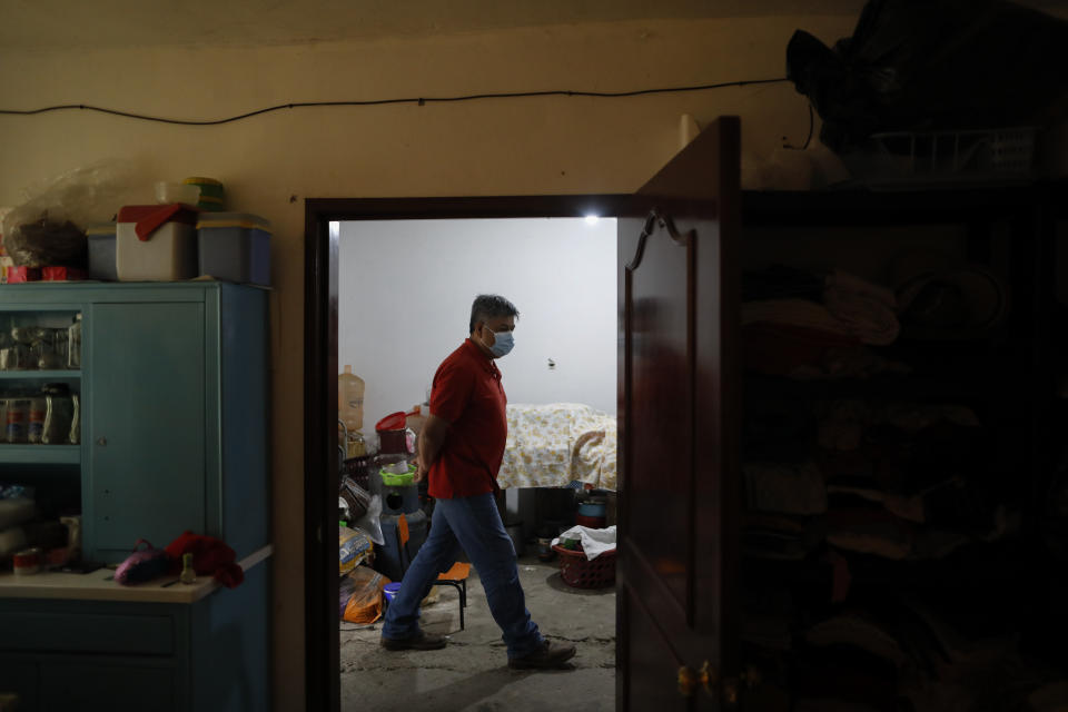 Jose Juan Serralde walks inside his home, which the family is still repairing and reinforcing following damage from a 2017 earthquake, in San Gregorio Atlapulco, Xochimilco, Mexico City, Wednesday, July 29, 2020. “You couldn’t isolate at home, we all shared the place,” said Serralde of his home where three generations lived. “It was a mistake on our part, but no one explained it to us until after what happened to my dad,” referring to his parents who died of COVID-19 in May. (AP Photo/Rebecca Blackwell)