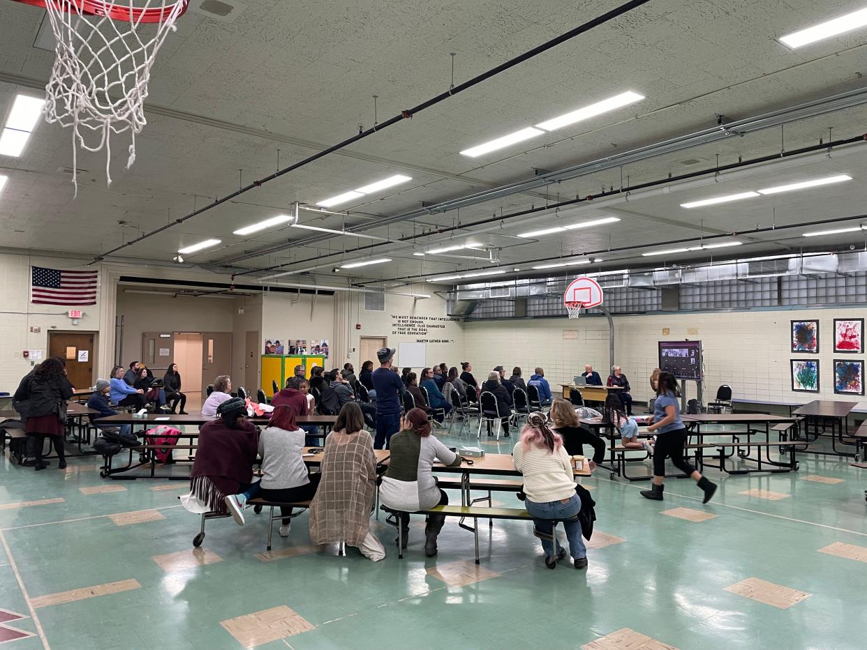 Families and staff gather in the gym of Penfield Montessori Academy on April 20 to craft a plan to save their school.