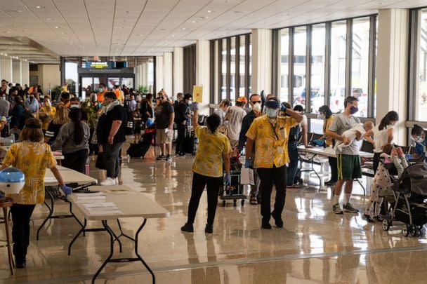 PHOTO: State officials checked to be sure all arriving visitors and residents alike had answered a health questionnaire, had their temperatures taken and shown proof of a negative COVID test, at Honolulu International Airport, Oct. 15, 2020 in Honolulu. (The Los Angeles Times via Getty Images)