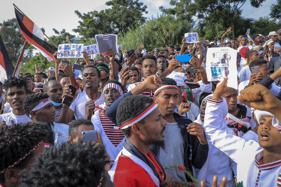 Oromos protest against the government and call for the release of prominent opposition figure Jawar Mohammed and others, seen on placards, during the annual Irreecha festival in the capital Addis Ababa, Ethiopia, Saturday, Oct. 2, 2021. Ethiopia's largest ethnic group, the Oromo, on Saturday celebrated the annual Thanksgiving festival of Irreecha, marking the end of winter where people thank God for the blessings of the past year and wish prosperity for the coming year. (AP Photo)