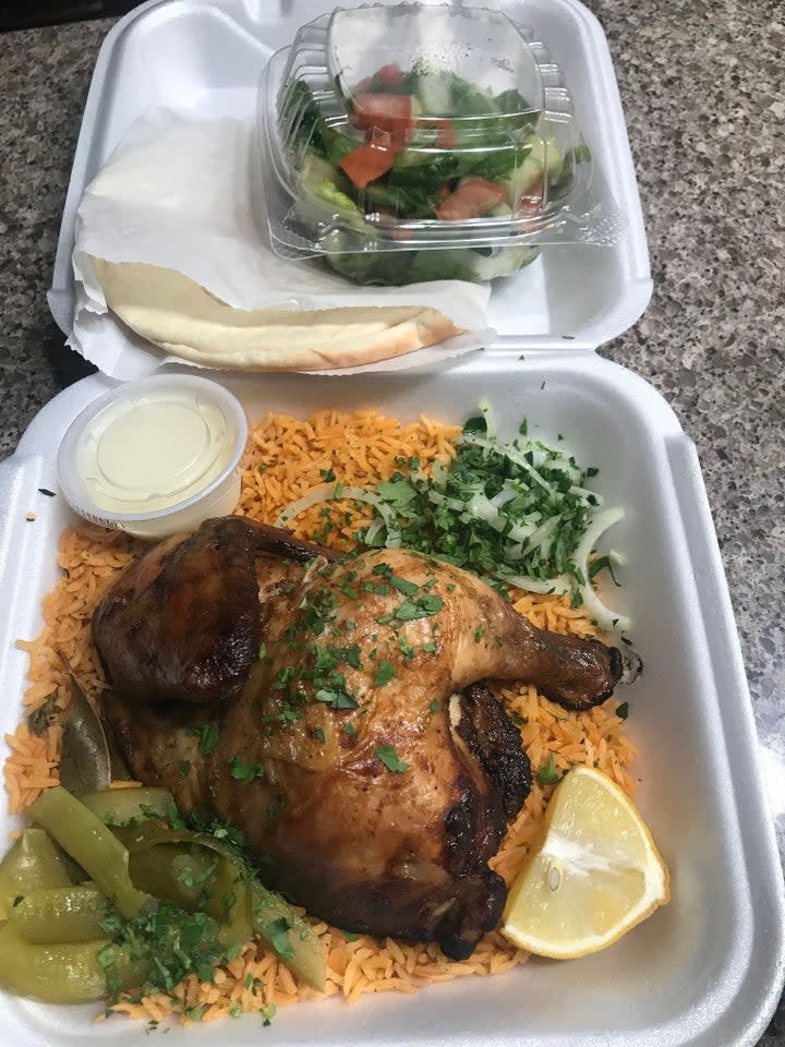 The Taste of Jerusalem's marinated half chicken is cooked on a grill and served with your choice of rice and a Jerusalem salad. Image via John Ferak/Patch Editor