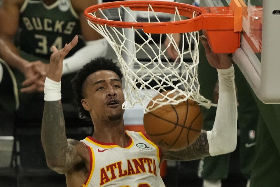 Atlanta Hawks' John Collins dunks during the second half of Game 1 of the NBA Eastern Conference basketball finals game against the Atlanta Hawks Wednesday, June 23, 2021, in Milwaukee. (AP Photo/Morry Gash)