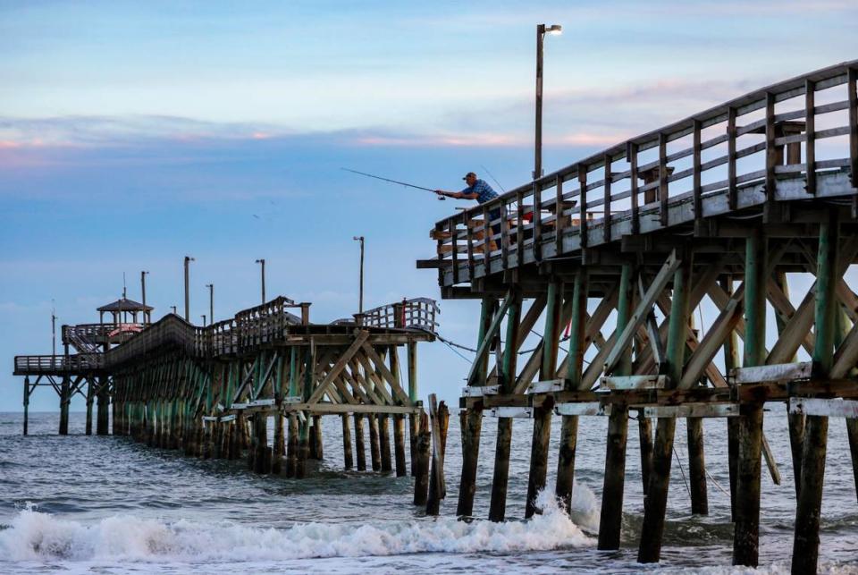A fisherman casts from the broken Cherry Grove Pier in North Myrtle Beach, S.C. Myrtle Beach area piers took a battering from Hurricane Ian this year but a strong pier culture prevails drawing fisherman and tourist back year after year. October 12, 2022.