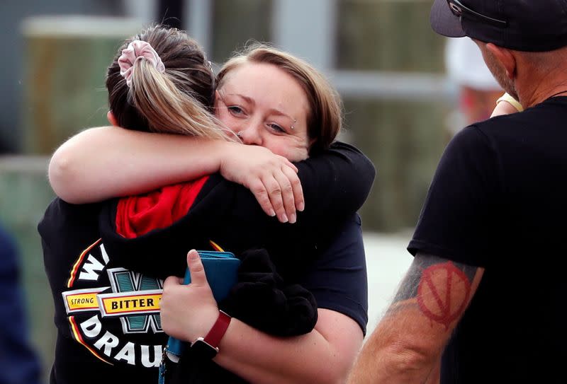 Relatives hug as they wait for rescue mission, following the White Island volcano eruption in Whakatane