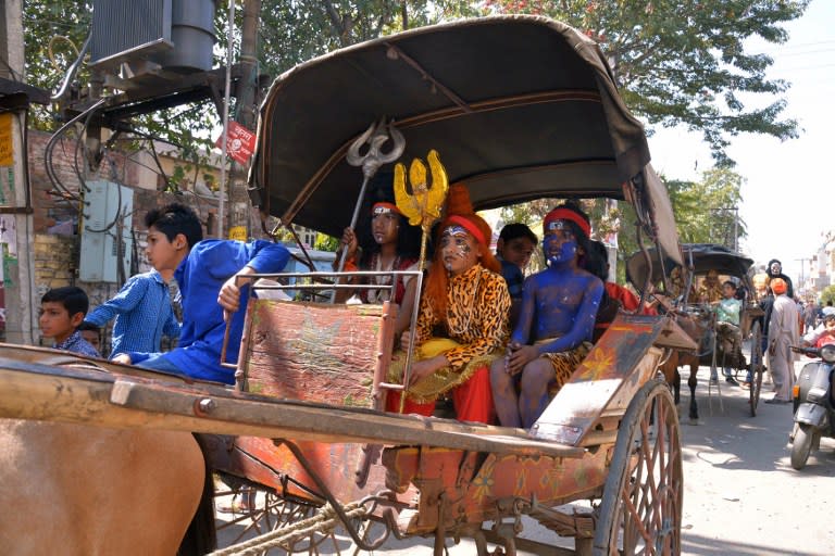 <p>Young Indian Hindu devotees dressed as Hindu deities take part in a procession during the Maha Shivaratri festival in Amritsar on March 7, 2016. The festival of Maha Shivaratri is marked by Hindus through fasting and offering prayers in a night-long vigil. </p>