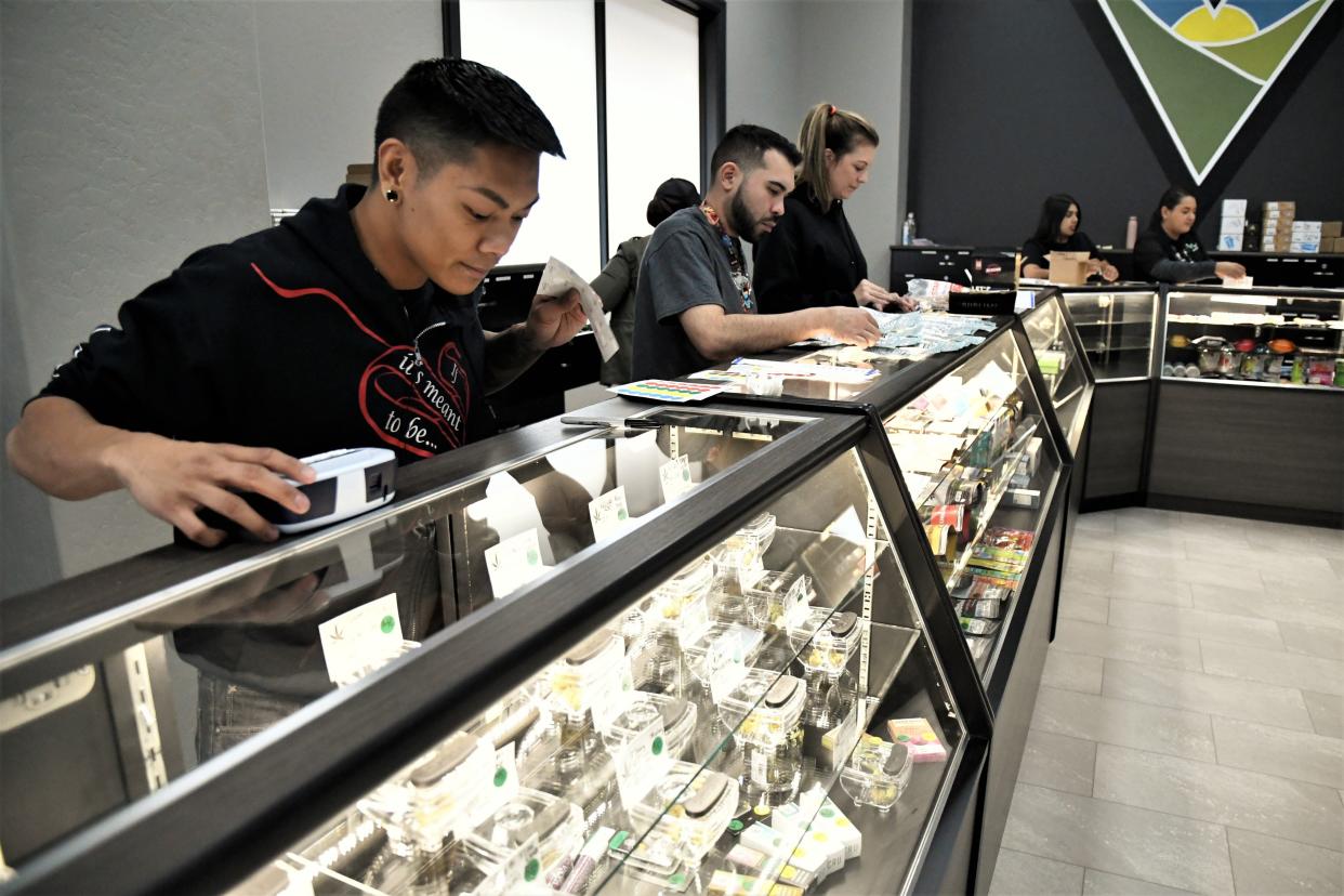 Carlo Raneses gets a display case at Farmersville's Valley Pure ready for the businesses grand opening.