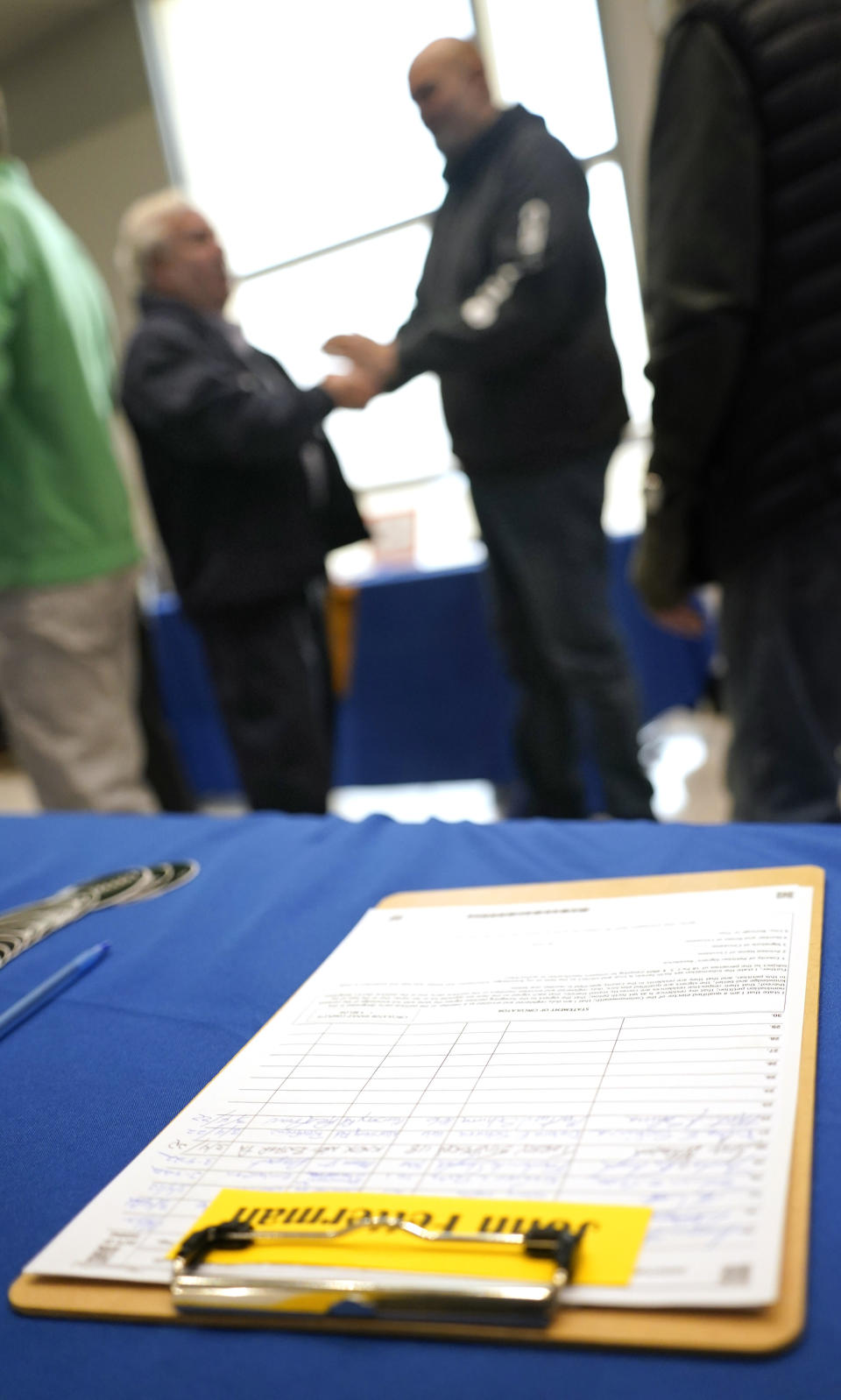 In this photo made on Friday, March 4, 2022, a ballot petition for the upcoming Pennsylvania primary election, is on a table in front of Pennsylvania Lt. Gov. John Fetterman, who is running for the party nomination for the U.S. Senate, as he visits with people attending a Democratic Party event for candidates to meet and collect signatures at the Steamfitters Technology Center in Harmony, Pa. The irreverent, blunt, 6 feet 8, tattooed Fetterman faces the Pennsylvania's Democratic Party committee backed U.S. Rep. Conor Lamb and Malcolm Kenyatta, a second-term state representative from Philadelphia. (AP Photo/Keith Srakocic)