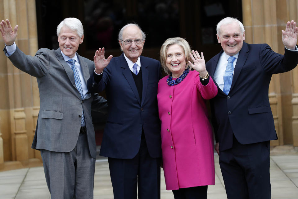 Former US President Bill Clinton, from left, former U.S. Sen. George Mitchell, former US Secretary of State Hillary Clinton and Bertie Ahern wave to journalists on the first day of a three-day international conference at Queen's University Belfast to mark the 25th anniversary of the Good Friday Agreement, in Belfast, Northern Ireland, Monday, April 17, 2023. Former U.S. President Bill Clinton and past leaders of the U.K. and Ireland are gathering in Belfast on Monday, 25 years after their charm, clout and determination helped Northern Ireland strike a historic peace accord. (AP Photo/Peter Morrison)