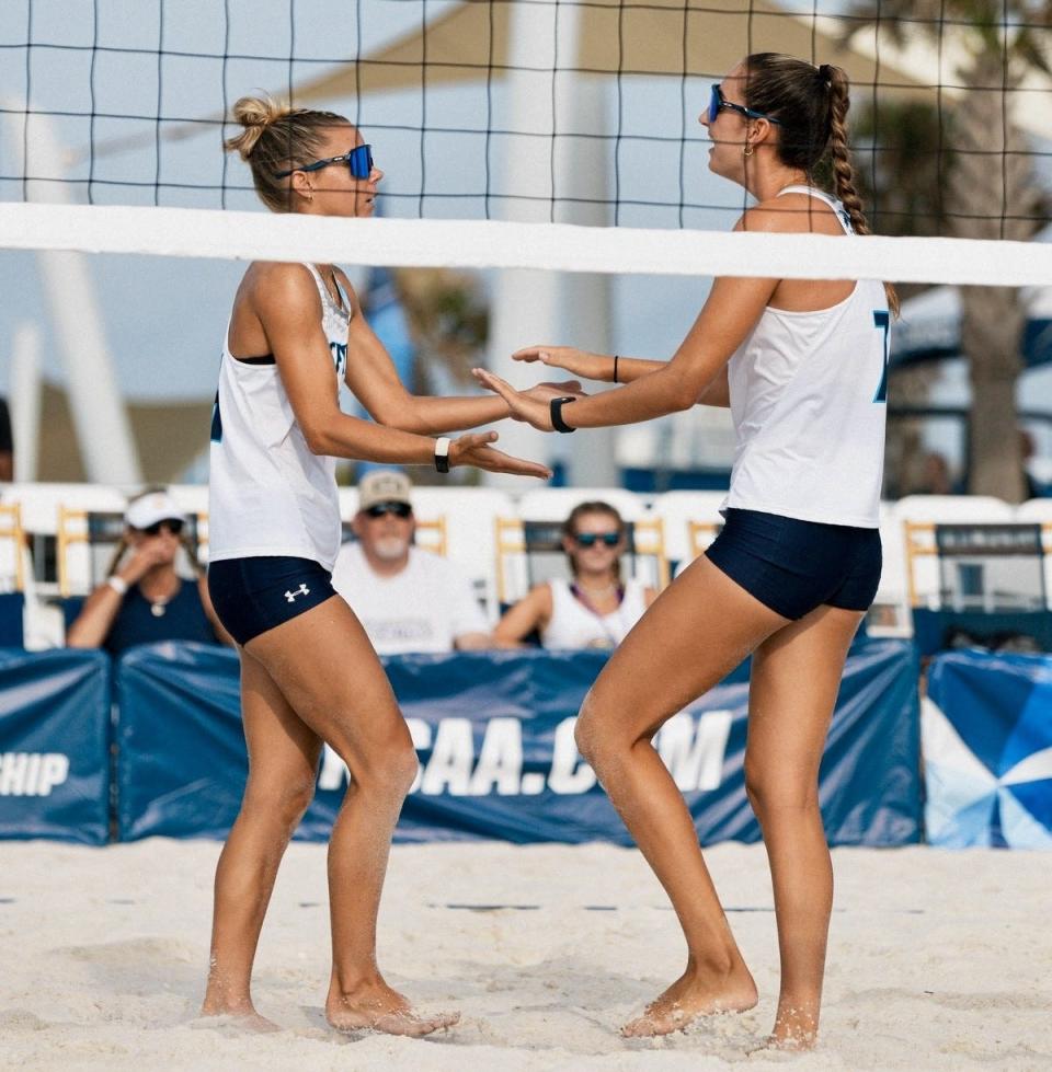 University of North Florida beach volleyball duo Madison Espy (left) and Presley Murray celebrate a point won against Chattanooga in the first round of the NCAAA Beach Volleyball Tournament on Friday at the Gulf Shores (Ala.) Public Beach. They won their match to lead UNF to a 3-0 victory.