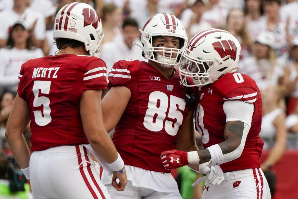 Wisconsin's Clay Cundiff is congratulated after catching a touchdown pass during the first half of an NCAA college football game Saturday, Sept. 10, 2022, in Madison, Wis. (AP Photo/Morry Gash)