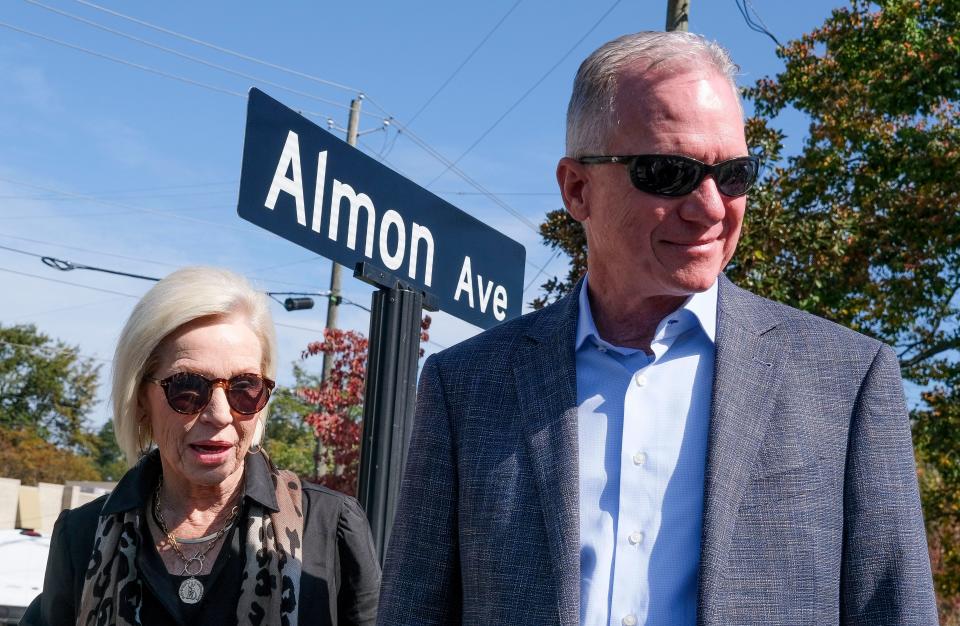 The City of Tuscaloosa renamed 21st Avenue as Almon Avenue in honor of Robert Almon Jr. on Friday, Oct. 27, 2023. Robert Almon and his sister Julie Jamison stand in front of the sign commemorating their father.