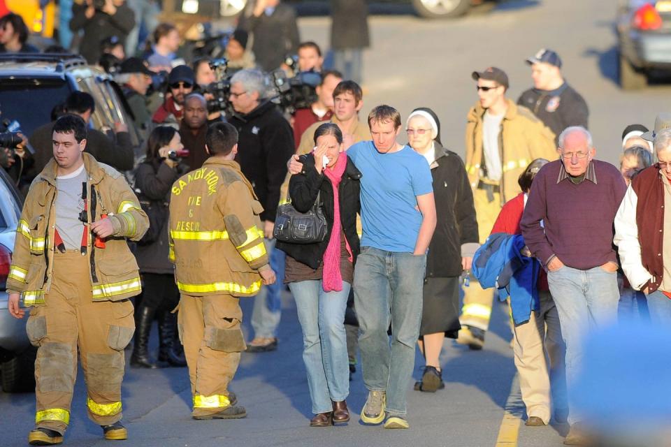 <p>Robbie and Alyssa Parker stand outside a firehouse near Sandy Hook Elementary School in Newtown, Connecticut. The Parkers' daughter, Emilie, was one of the 20 children killed in the shooting. </p>