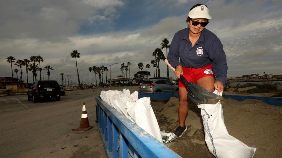 Long Beach lifeguard Molica Anderson, 37, fills sandbags for residents to prevent possible flooding from the upcoming storm at 72nd Place Lifeguard Station in Long Beach on Jan. 31. A second major storm is expected to rake across California beginning Saturday night through Tuesday.