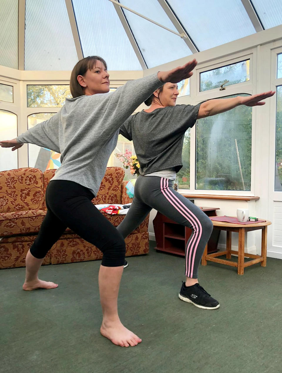 Care workers Amanda Taylor and Vikki Jenks enjoying some yoga in their free time (Picture: SWNS)