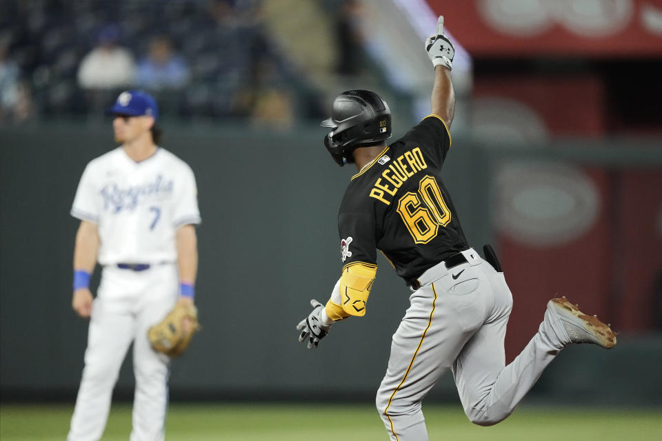 Pittsburgh Pirates' Liover Peguero celebrates as he runs home after hitting a three-run home run during the ninth inning of a baseball game against the Kansas City Royals Tuesday, Aug. 29, 2023, in Kansas City, Mo. (AP Photo/Charlie Riedel)