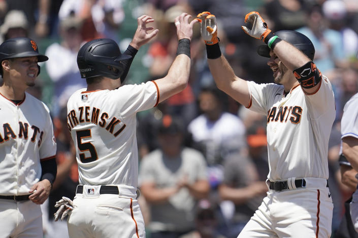 San Francisco Giants' Evan Longoria, right, celebrates after hitting a three-run home run that scored Wilmer Flores, left, and Mike Yastrzemski (5) during the first inning of a baseball game against the New York Mets in San Francisco, Wednesday, May 25, 2022. (AP Photo/Jeff Chiu)