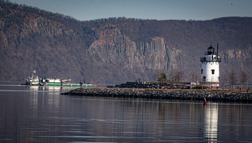 A tug boat pushing a barge up the Hudson River passes the Tarrytown Lighthouse as it heads towards its destination in Newburgh April 9, 2024.