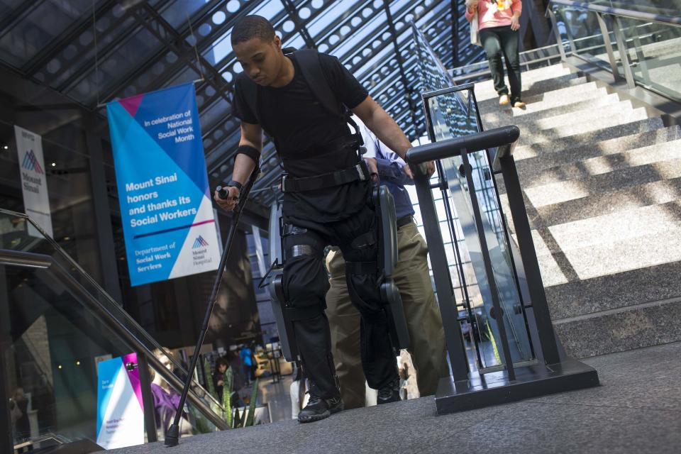 22-year-old Errol Samuels from Queens, New York, who lost the use of his legs in 2012 after a roof collapsed onto him at an off-campus house party near where he was attending college in upstate New York, practices walking up steps with a ReWalk electric powered exoskeletal suit during a therapy session at the Mount Sinai Medical Center in New York City March 26, 2014. Made by the Israeli company Argo Medical Technologies, ReWalk is a computer controlled device that powers the hips and knees to help those with lower limb disabilities and paralysis to walk upright using crutches. Allan Kozlowski, assistant professor of Rehabilitation Medicine at Icahn School of Medicine at Mount Sinai hospital, where patients like Samuels are enrolled in his clinical trials of the ReWalk and another exoskeleton, the Ekso (Ekso Bionics) hopes machines like these will soon offer victims of paralysis new hope for a dramatically improved quality of life and mobility. The ReWalk is currently only approved by the U.S. Food and Drug Administration (FDA) for use in rehabilitation facilities like at Mount Sinai, as they weigh whether to approve the device for home use as it already is in Europe. Picture taken March 26, 2014. REUTERS/Mike Segar