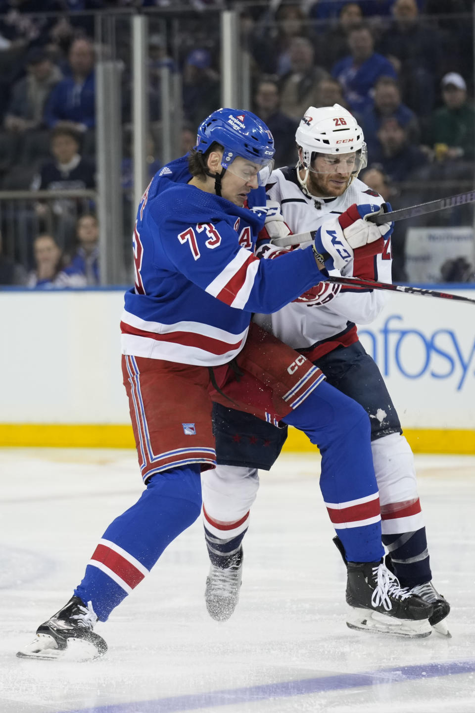 New York Rangers' Matt Rempe, left, collides with Washington Capitals' Nic Dowd during the third period in Game 1 of an NHL hockey Stanley Cup first-round playoff series, Sunday, April 21, 2024, in New York. (AP Photo/Seth Wenig)