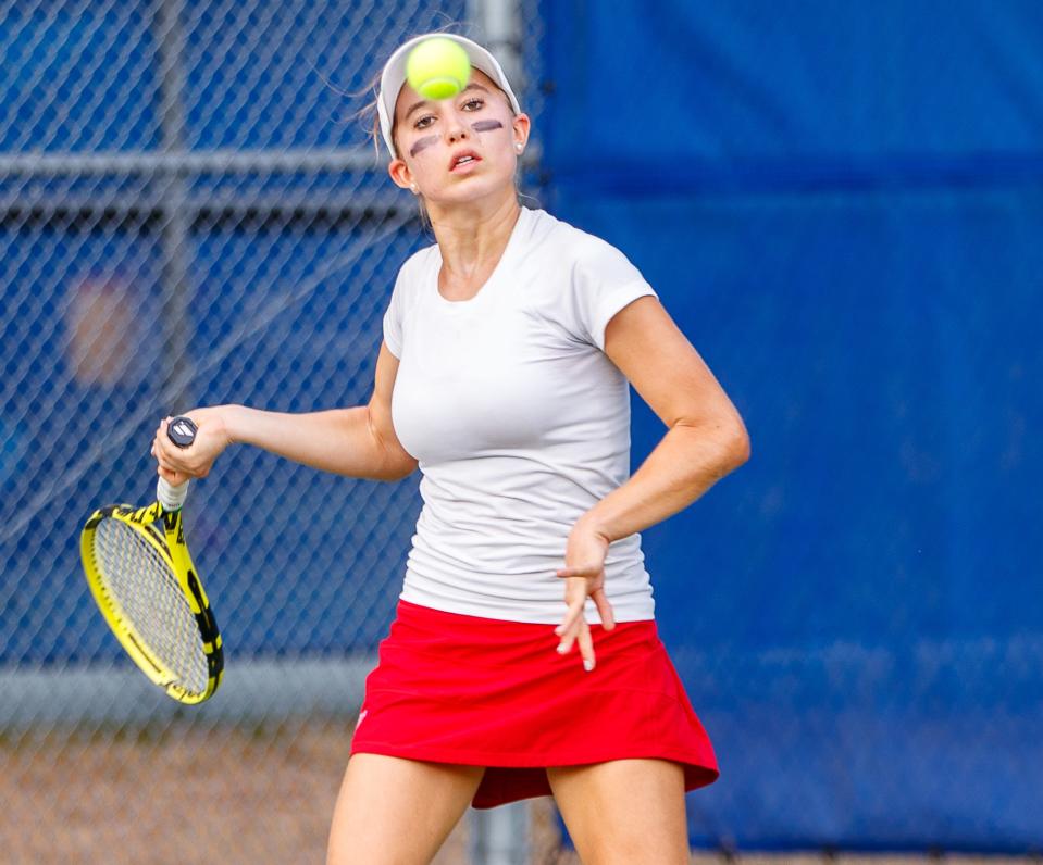 Westlake's Ava Bozic returns a shot during a 2021 district tennis match. Now a senior, she runs a jewelry business in her spare time and even does a little coaching.