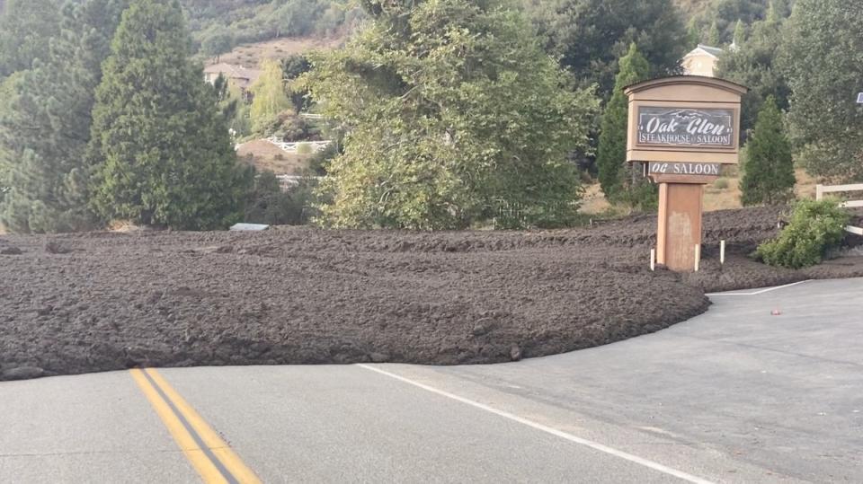 Waves of mud pour down around a restaurant in Oak Glen, California on Monday (Roger Seheult via REUTERS)