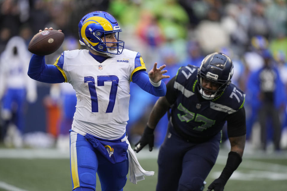 Los Angeles Rams quarterback Baker Mayfield (17) throws as Seattle Seahawks defensive tackle Quinton Jefferson (77) closes in during the second half of an NFL football game Sunday, Jan. 8, 2023, in Seattle. (AP Photo/Stephen Brashear)