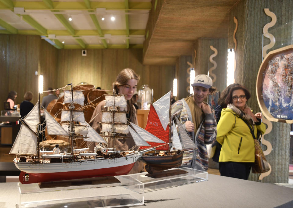 Visitors attend an exhibition of model ships made by the Madagascar company Le Village and on display at the Homo Faber 2024 show in Venice, Italy, Friday, Sept. 13, 2024.(AP Photo/Luigi Costantini)