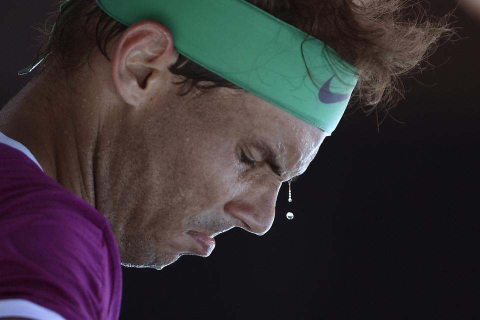 Sweat drops from the face of Rafael Nadal of Spain during a break in his second round match against Yannick Hanfmann of Germany at the Australian Open tennis championships in Melbourne, Australia, Wednesday, Jan. 19, 2022. (AP Photo/Andy Brownbill)