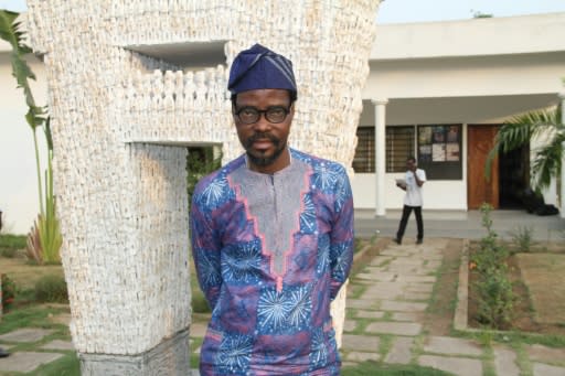 Dominique Zinkpe, a Beninese contemporary artist and director of Cotonou's Centre for arts and culture, poses outside the Petit Musee de la Recade, hosting the arefacts returned from France