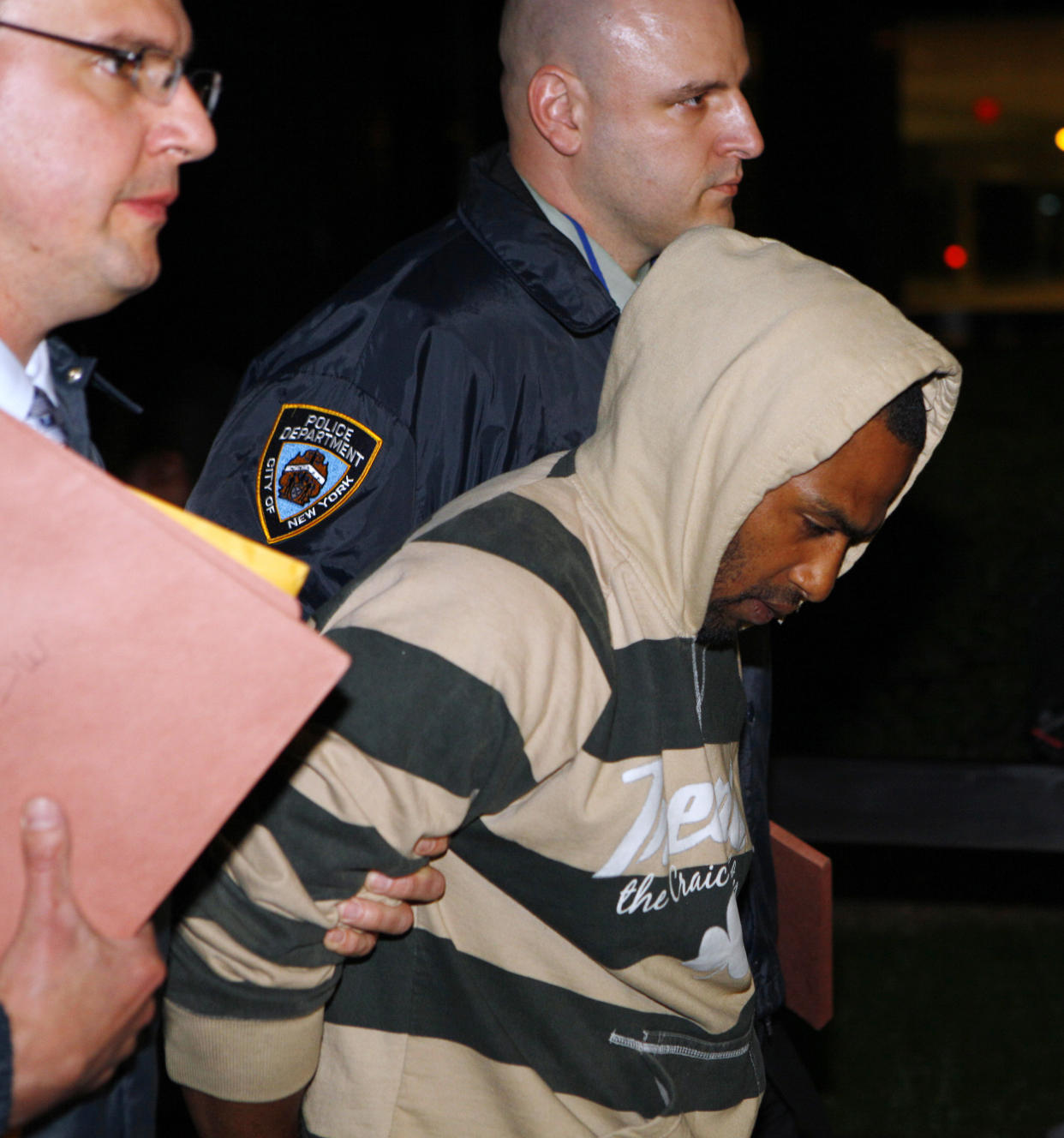 David Williams is walked out of the FBI offices after being taken into custody in New York May 21, 2009. (Reuters)