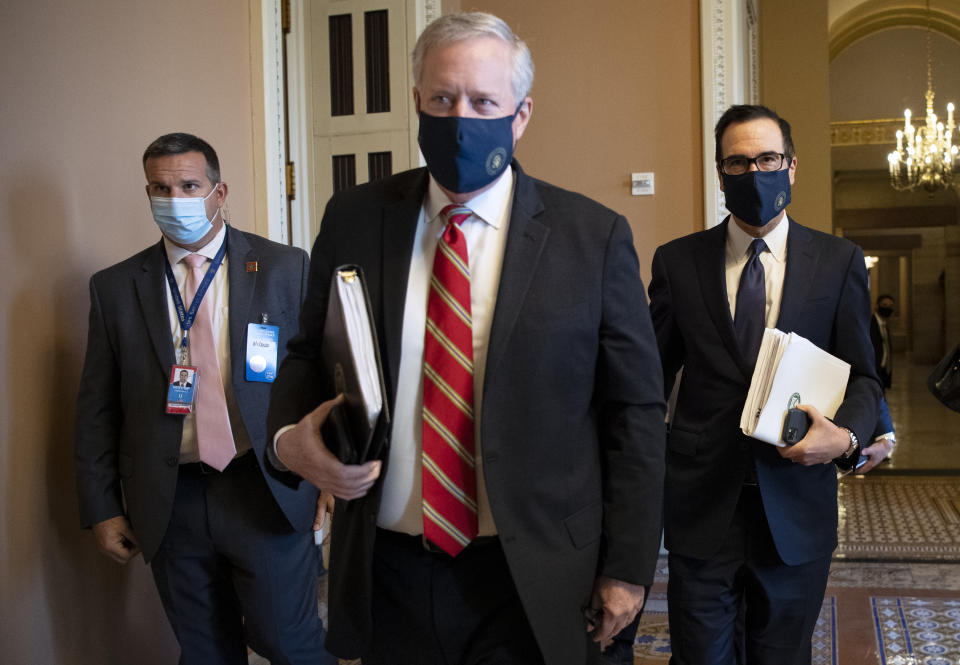 UNITED STATES - JULY 29: White House Chief of Staff Mark Meadows, center, and Treasury Secretary Steven Mnuchin depart from a meeting with Senate Republican leadership to continue negotiations on the latest stimulus bill on Wednesday, July 29, 2020. (Photo by Caroline Brehman/CQ-Roll Call, Inc via Getty Images)