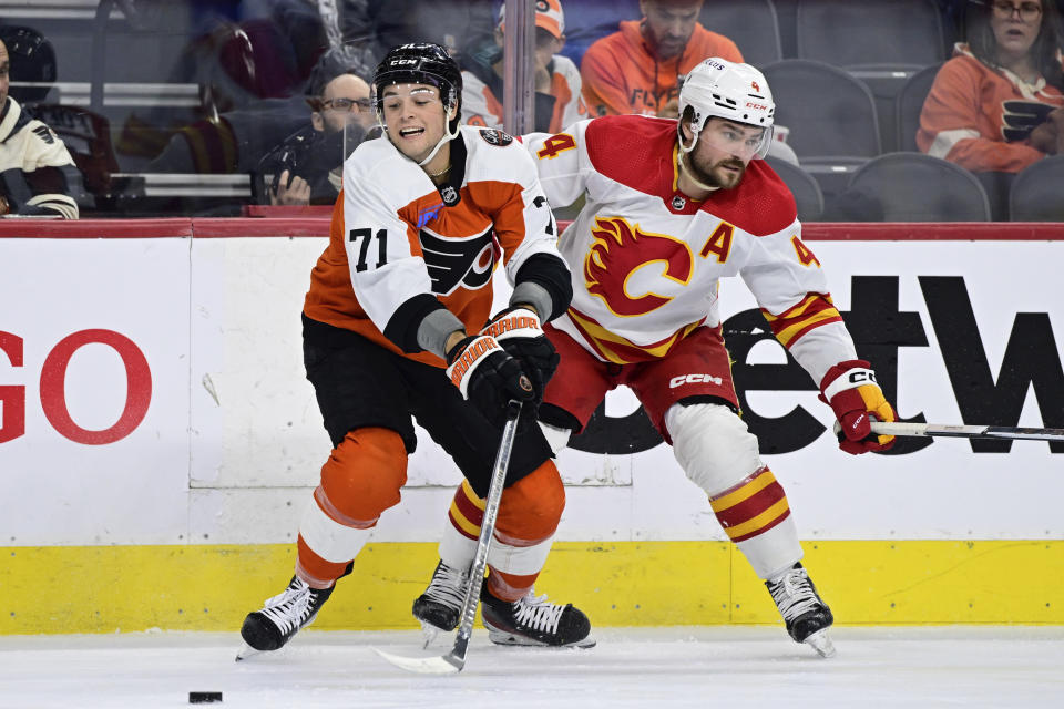 Philadelphia Flyers' Tyson Foerster (71) passes the puck against Calgary Flames' Rasmus Andersson (4) during the first period of an NHL hockey game, Saturday, Jan. 6, 2024, in Philadelphia. (AP Photo/Derik Hamilton)